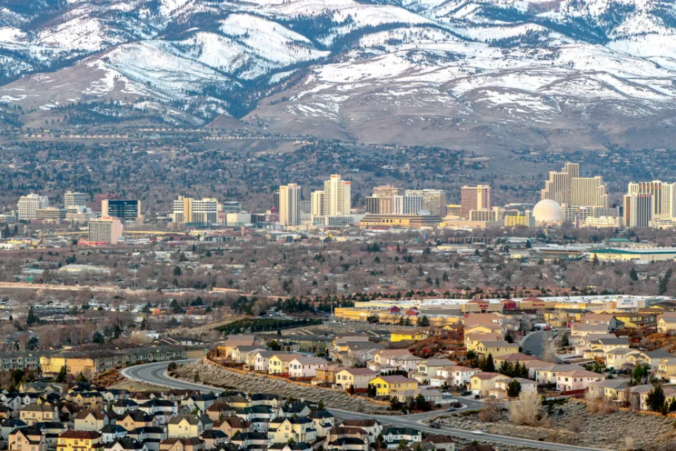 Aerial view of Reno, Nevada against snow-capped mountains in winter
